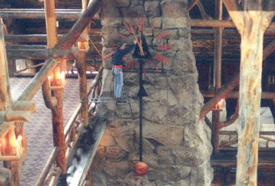 
A workman adjusts a clock on a large stone fireplace in the lobby of the Old Faithful Inn in Yellowstone National Park, Wyo. Even stone fireplaces as large as this can be cleaned by mixing DAP TSP Substitute and bleach in warm water. 
 (File Photo / The Spokesman-Review)