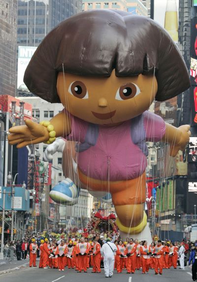 In this 2007 file photo, the Dora the Explorer balloon moves down Broadway through Times Square during the Macy’s Thanksgiving Day parade in New York. “Dora the Explorer” is seen today in 151 markets and is translated to 30 languages.  (Associated Press)