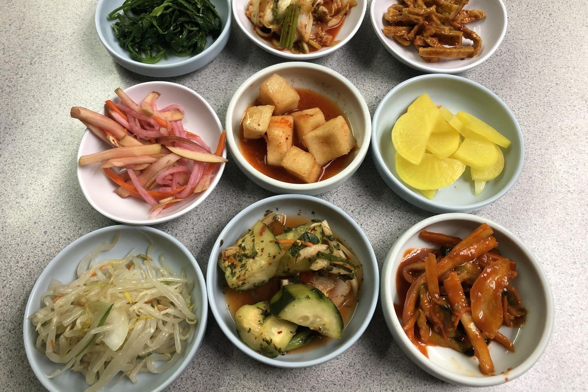 An array of complimentary Korean side dishes, or banchan, at Kim’s Korean Restaurant on North Division near Gonzaga. (Don  Chareunsy / The Spokesman-Review)