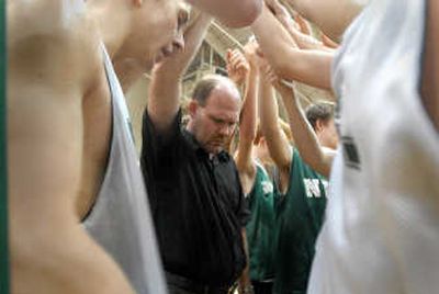 
NWC coach Ray Ricks, center, bows his head with his players as John Graham, left, says a prayer at the end of practice Tuesday.
 (Jesse Tinsley / The Spokesman-Review)