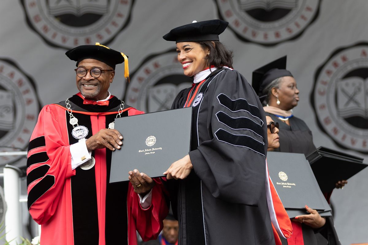 Clark Atlanta University President George T. French Jr. poses for photographs with the graduates after they received their diplomas at the commencement ceremony in Panther Stadium on Saturday, May 20, 2023.    (Steve Schaefer/The Atlanta Journal-Constitution/TNS)