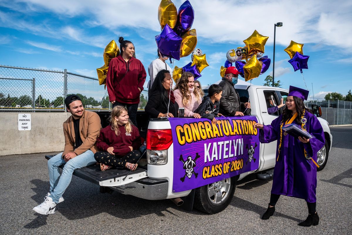 After walking the stage and receiving her diploma, third generation Rogers high School graduate Katelyn Anderson, 17, joins her family during a the school’s drive-thru graduation ceremony, Sat., June 6, 2020. (Colin Mulvany / The Spokesman-Review)