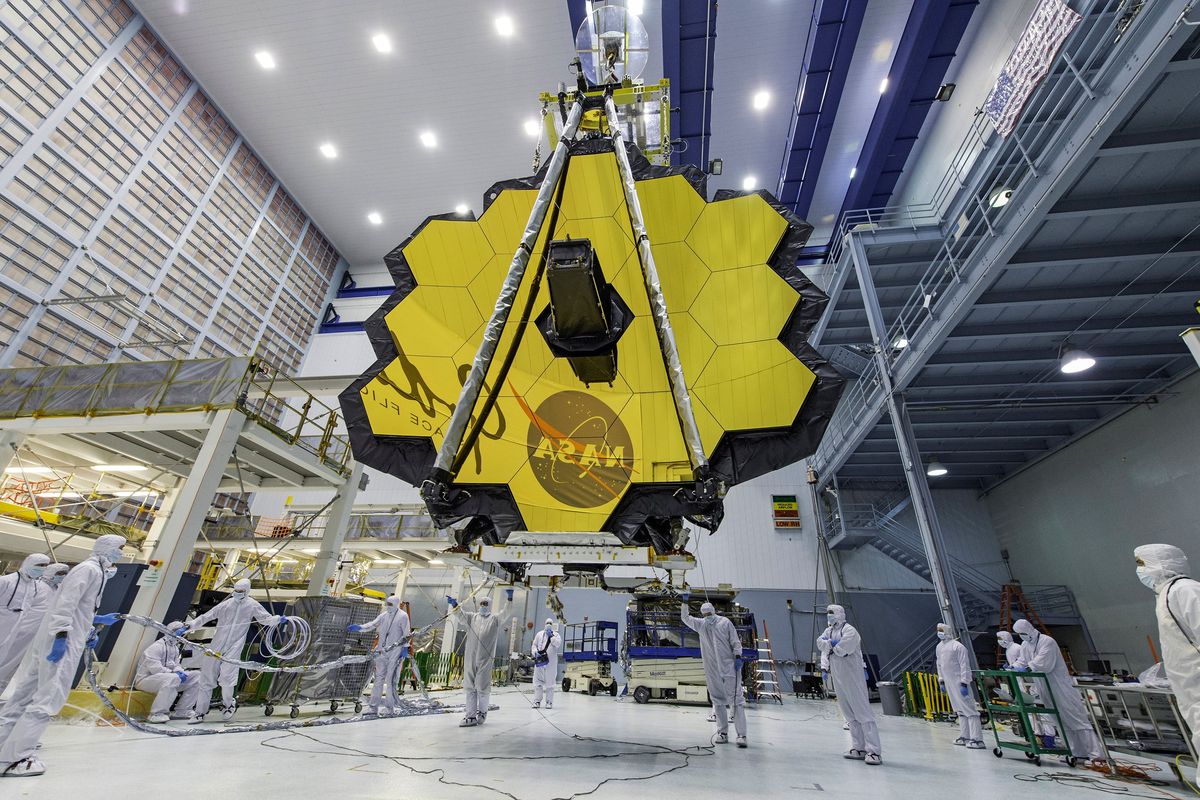 FILE - In this April 13, 2017 photo provided by NASA, technicians lift the mirror of the James Webb Space Telescope using a crane at the Goddard Space Flight Center in Greenbelt, Md. NASA announced Tuesday, Dec. 14, 2021, that next week’s launch of its new space telescope is delayed for at least two days because of a communication problem between the observatory and the rocket. Liftoff of the James Webb Space Telescope is now targeted for no earlier than Dec. 24.  (Laura Betz)