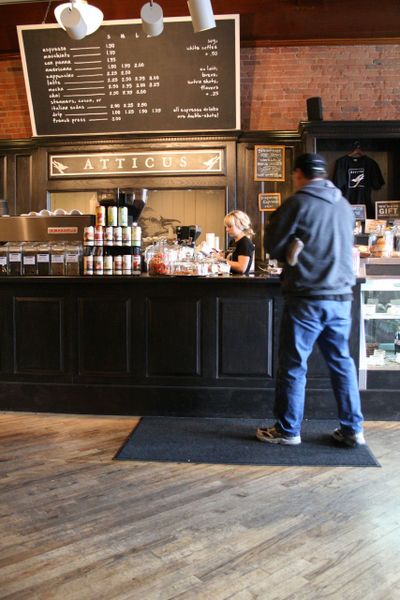 A customer waits for his order in the cafe portion of Atticus Coffee & Gifts, which offers 4 Seasons, Anvil and Bumper Crop coffee, its own sandwiches, and baked goods from Bouzies, Rocket and Sweetwater bakeries and Sante Restaurant & Charcuterie. (Megan Cooley)