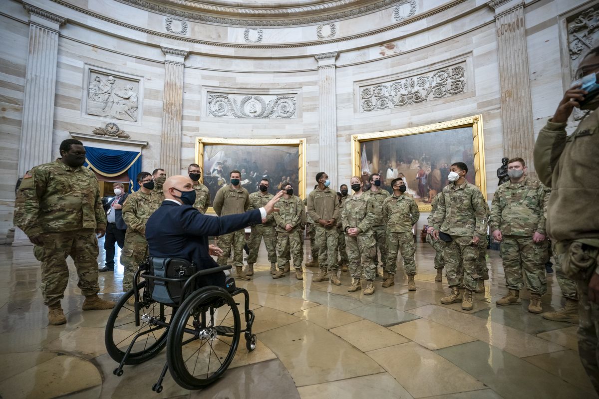 Rep. Brian Mast, R-Fla., left, visits with National Guard troops who are helping with security at the Capitol Rotunda in Washington, Wednesday, Jan. 13, 2021.  (J. Scott Applewhite)