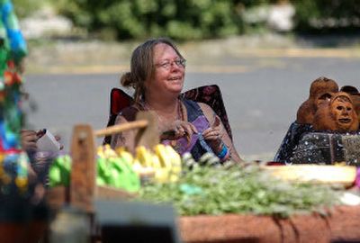 
Raynell Cook knits at the Peaceful Valley Artisans booth at the Humble Earth farmers market on Sunday. 
 (Liz Kishimoto / The Spokesman-Review)