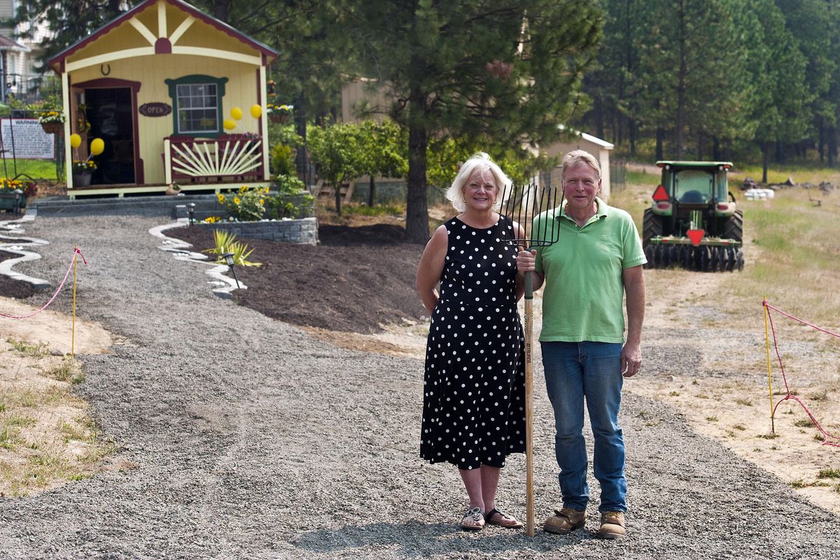 Ginger and Michael Kulpit of Sunshine Farm on Green Bluff pose for a photograph on Thursday, Aug. 16, 2018. (Kathy Plonka / The Spokesman-Review)