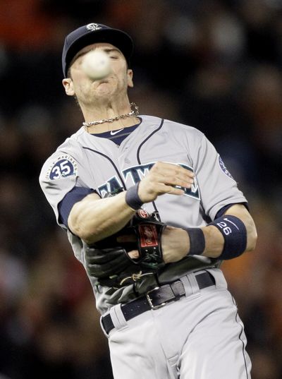 Mariners shortstop Brendan Ryan is late with a throw to first in the eighth inning. (Associated Press)
