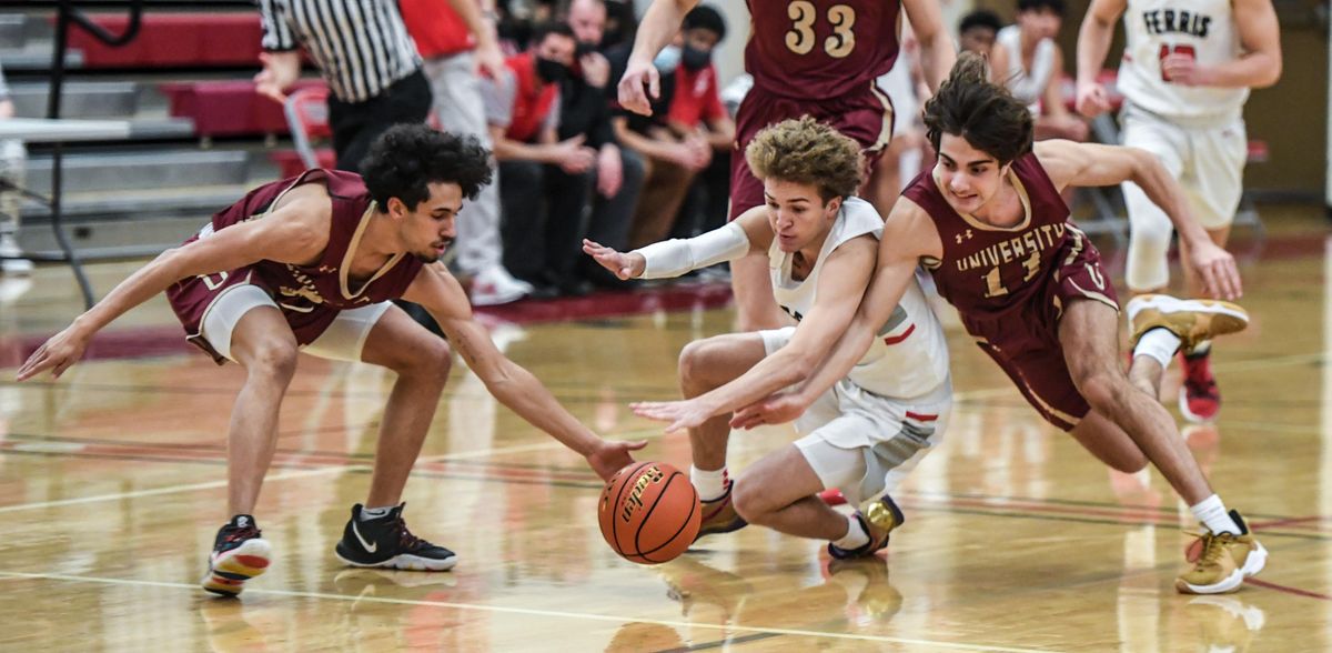 Ferris guard Trayce Atkins, center, battles University teammates Jeremiah Sibley, left, and Jalen King for a loose ball, Tuesday, Jan. 11, 2022 at Ferris High School.  (Dan Pelle/THE SPOKESMAN-REVIEW)