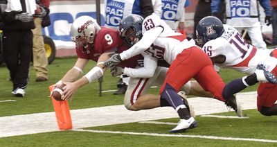 Associated Press WSU’s Kevin Lopina dives for the pylon and scores a touchdown. (Associated Press / The Spokesman-Review)