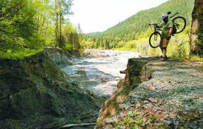 
Chris Gunter's biking trip along Whitechuck Road was halted in April by a massive hole where the road was washed out during a flood last October in the Mount Baker-Snoqualmie National Forest. Nature lovers could face a frustrating summer of blocked trails, impassable streams and upended bridges in the North Cascades, especially near Glacier Peak. Chris Gunter's biking trip along Whitechuck Road was halted in April by a massive hole where the road was washed out during a flood last October in the Mount Baker-Snoqualmie National Forest. Nature lovers could face a frustrating summer of blocked trails, impassable streams and upended bridges in the North Cascades, especially near Glacier Peak. 
 (Associated PressAssociated Press / The Spokesman-Review)