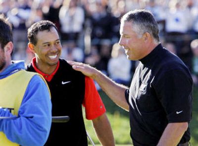 
Caddie Steve Williams, right, congratulated an upbeat Tiger Woods on Sunday after his win at the Target World Challenge. 
 (Associated Press / The Spokesman-Review)