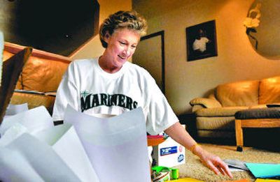 
Patty Phelps, of Rathdrum, packs gift boxes Wednesday  for Brandon Adam, a Sandpoint soldier who lost his legs in an explosion two weeks ago in Iraq. 
 (Kathy Plonka / The Spokesman-Review)