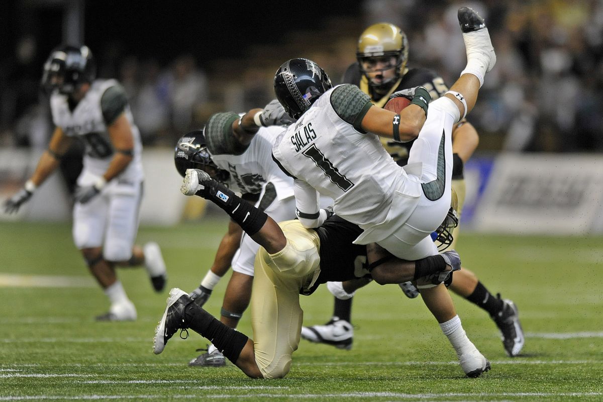 Idaho strong safety #3 Gary Walker upends Hawaii punt returner #1 Greg Salas during first-half action in the Kibbie Dome in Moscow, Idaho, Saturday, Oct. 17, 2009. Idaho took a 14-10 halftime lead. (Christopher Anderson / The Spokesman-Review)