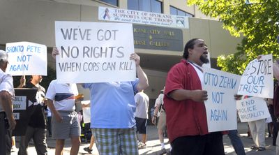 Protesters march Thursday in front of Spokane City Hall to highlight concerns over police actions and oversight.  (CHRISTOPHER ANDERSON / The Spokesman-Review)