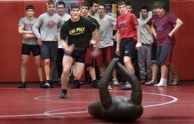 
Riverside wrestler Ryan DesRoches opens a drill at full speed while his teammates wait their turn at Monday's practice. 
 (Christopher Anderson / The Spokesman-Review)