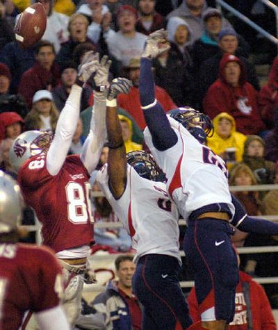 
WSU wide receiver Charles Dillon battles a pair of Arizona defenders for a pass in the end zone.
 (Christopher Anderson / The Spokesman-Review)