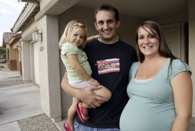 First-time homebuyers Lance and Kelli Thorson, shown at their rental home in Phoenix with 2-year-old daughter Mia, are making offers on houses before they even see them. (Associated Press / The Spokesman-Review)