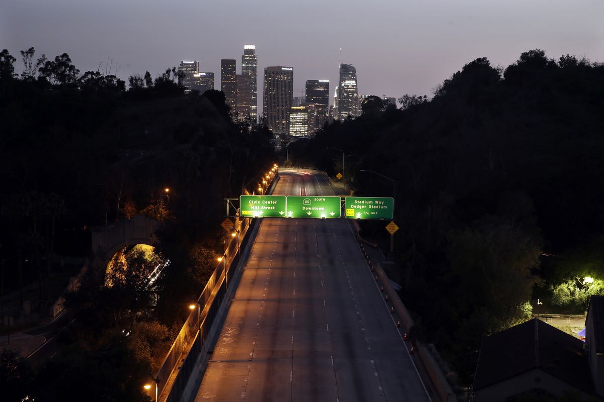 In this April 2, 2020 photo, light traffic is seen on the 110 freeway with the city skyline in the background in Los Angeles. California, for decades a symbol of boundless growth and opportunity that attracted people from across the U.S. and abroad, has stagnated. Census data expected later this month will reveal what demographers and observers have long known: That California is now growing at a record slow rate and behind rival political states like Texas and Florida. That could cause the state to lose a U.S. House seat for the first time in its history.  (Marcio Jose Sanchez)