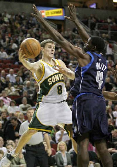 
Sonics guard Luke Ridnour looks to slip a pass around the Mavericks' Michael Finley at KeyArena. 
 (Associated Press / The Spokesman-Review)