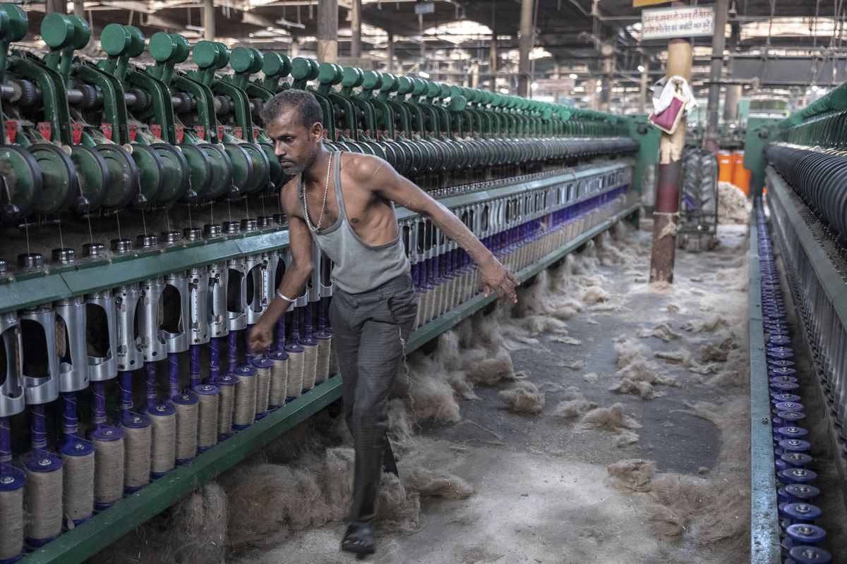 People work Aug. 30 at the Hukumchand Jute Mill in the Indian state of West Bengal, where the country’s jute industry is concentrated. India’s deep-rooted jute industry has struggled for decades, undercut by cheaper synthetics.  (New York Times)