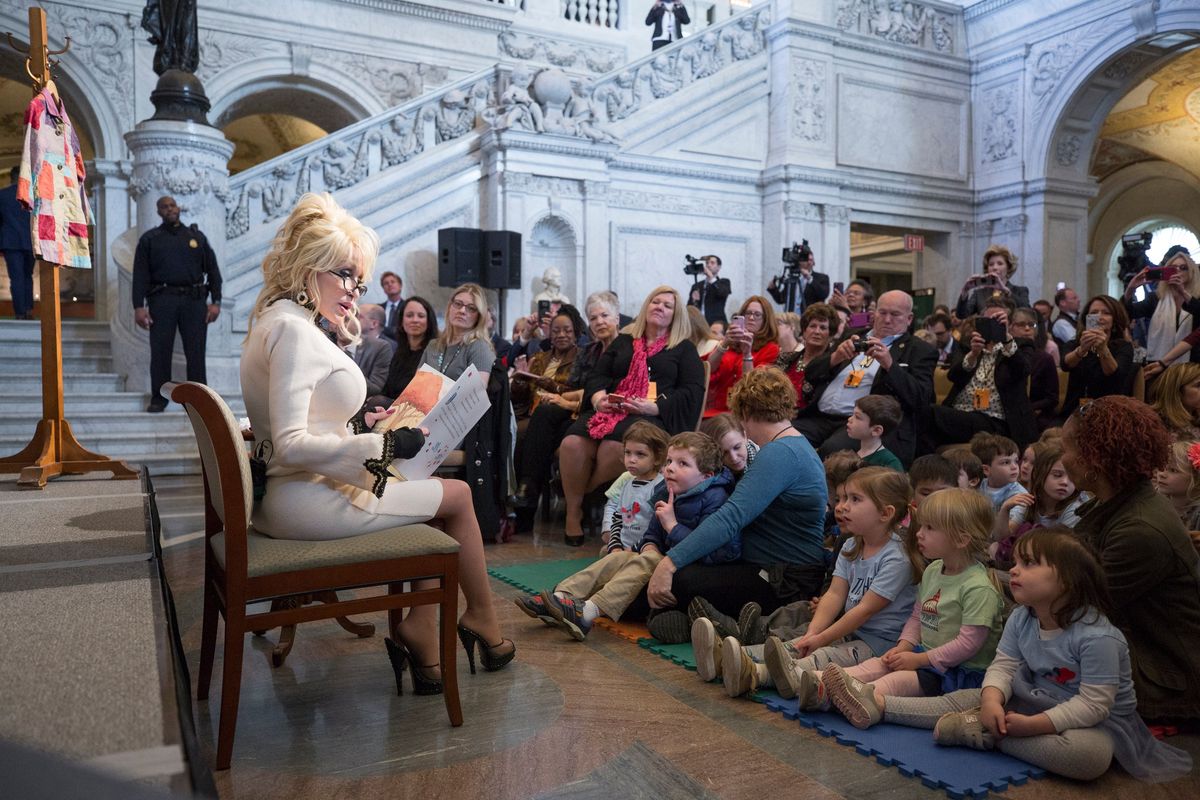 Dolly Parton reads to children at the Library of Congress in 2018. Her Imagination Library has gifted more than 197 million books to kids.  (Dollywood Company)