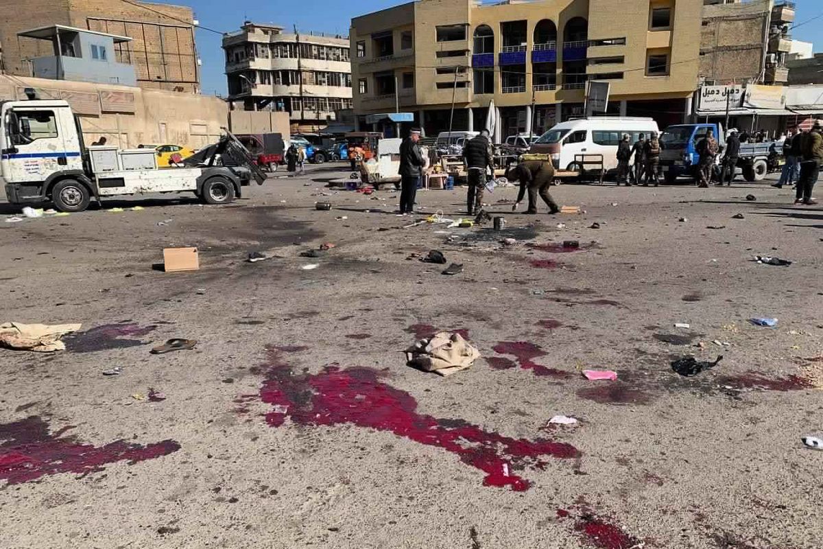 Security forces work at the site of a deadly bomb attack in a market selling used clothes, Iraq, Thursday, Jan. 21, 2021. Twin suicide bombings hit Iraq