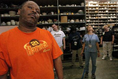 
Allen Campbell rolls his neck while participating in a stretching routine at work at Replacements, Ltd. in Greensboro, N.C. Twice a day the warehouse staff is encourage to stretch and loosen up their upper body to counteract their repetitive routine on an assembly line.
 (Associated Press / The Spokesman-Review)