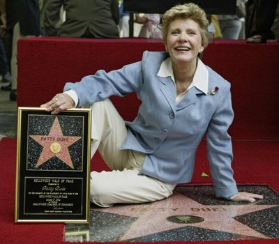In this Aug. 17, 2004 file photo, actress Patty Duke is honored with a star on the Hollywood Walk of Fame in Los Angeles.Duke, who won an Oscar as a child at the start of an acting career that continued through her adulthood, died Tuesday, March 29, 2016, of sepsis from a ruptured intestine. She was 69. (AP Photo/Damian Dovarganes, File)