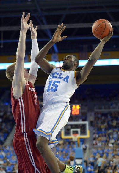 UCLA’s Shabazz Muhammad puts up a shot over Brock Motum. (Associated Press)
