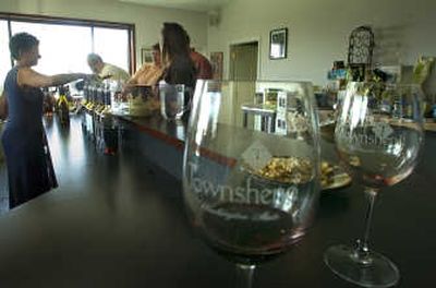 
Jill Rider pours wine at Townshend Cellars last week for visitors from Montana. The winery is growing in popularity and specializes in red wines.  Spokesman-Review
 (CHRISTOPHER ANDERSON  Spokesman-Review / The Spokesman-Review)