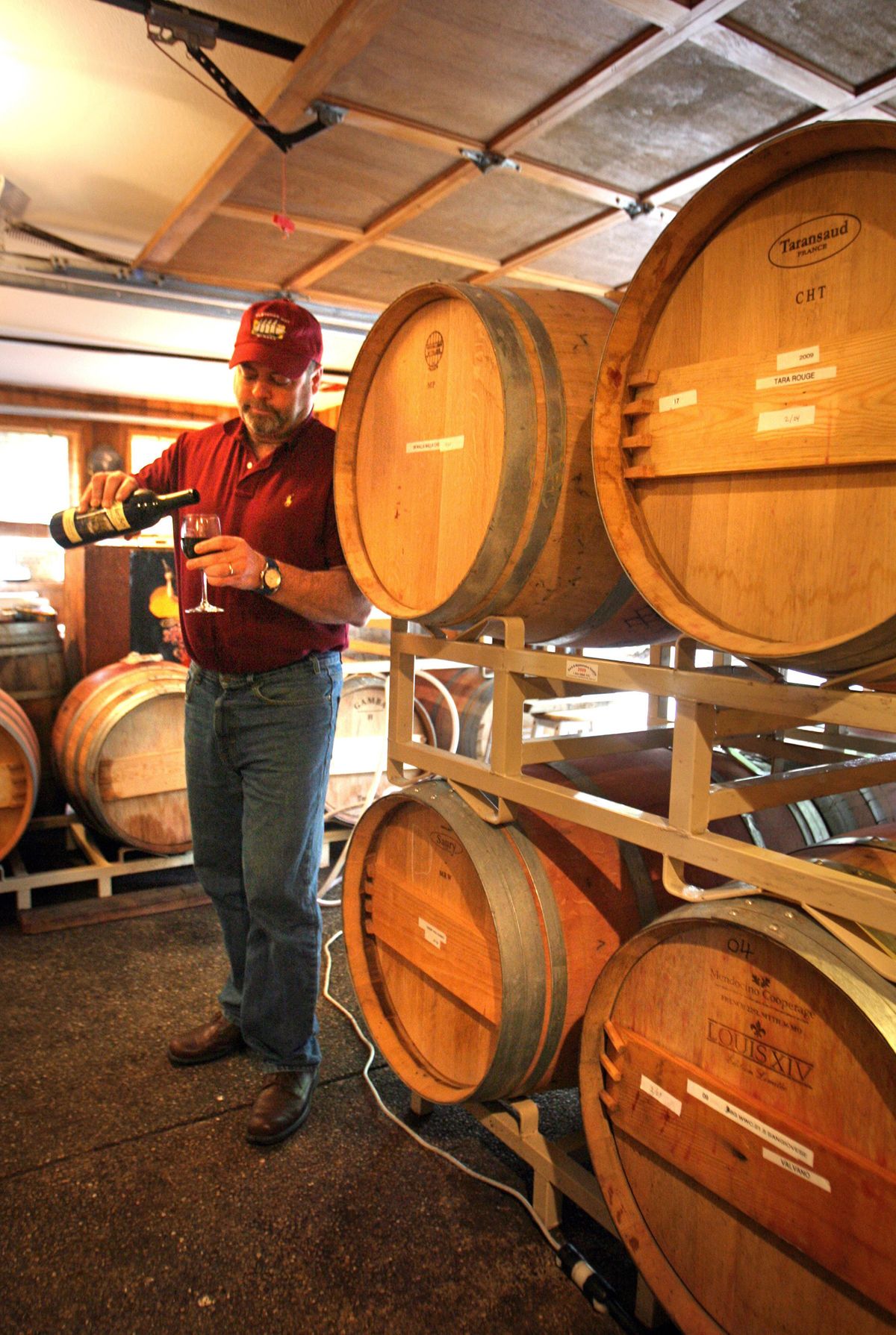 Jim Wilford, owner of Fletcher Bay Winery on Bainbridge Island in Puget Sound, pours a glass of red wine.