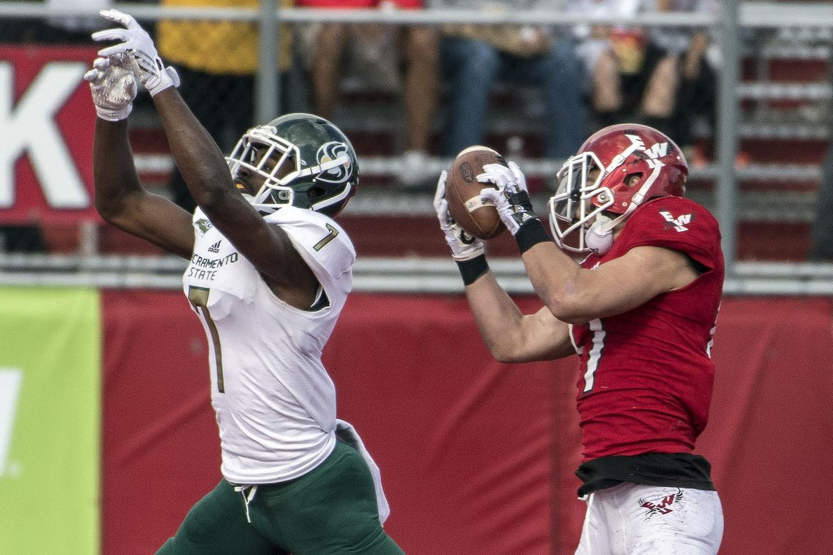 Eastern Washington defensive back Jake Hoffman, right, comes down with an interception during a Sept. 30 game against Sacramento State. (Colin Mulvany / The Spokesman-Review)