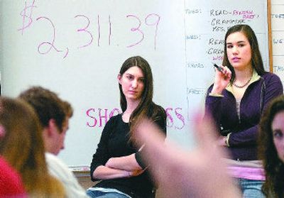 
Erin Fitzpatrick, left, and Lillian Dubiel listen last month as members of a Lewis and Clark High School group called Los Hermanos suggest fundraising ideas. The group has raised more than $30,000  to finance  a high school in the village of Huizisilapa, El Salvador. 
 (Christopher Anderson / The Spokesman-Review)