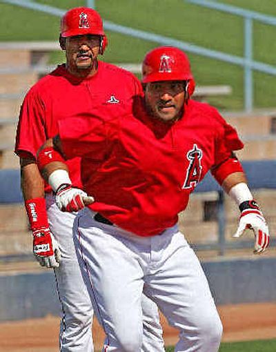 
Los Angeles Angels catcher Jose Molina, rear, watches his brother, catcher Bengie, run the bases during spring training in early March. 
 (Associated Press / The Spokesman-Review)