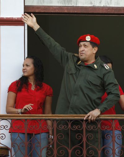 President Hugo Chavez greets supporters next to his daughter Rosa Virginia in Caracas, Venezuela, on Monday. (Associated Press)