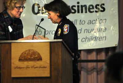 
Spokane police Chief Anne Kirkpatrick accepts an award  from Mary Ann Murphy, executive director of the Spokane Prevention of Child Abuse and Neglect Council, on Friday at Mukogawa Fort Wright Institute in Spokane. 
 (Rajah Bose / The Spokesman-Review)