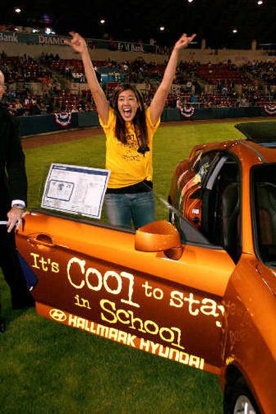 
Nikiko Johnson of Mt. Spokane High School celebrates after winning a car on June 19 at Avista Stadium in a drawing of the 69 students who had perfect attendance during their senior year. 
 (Sean Lumsden / The Spokesman-Review)