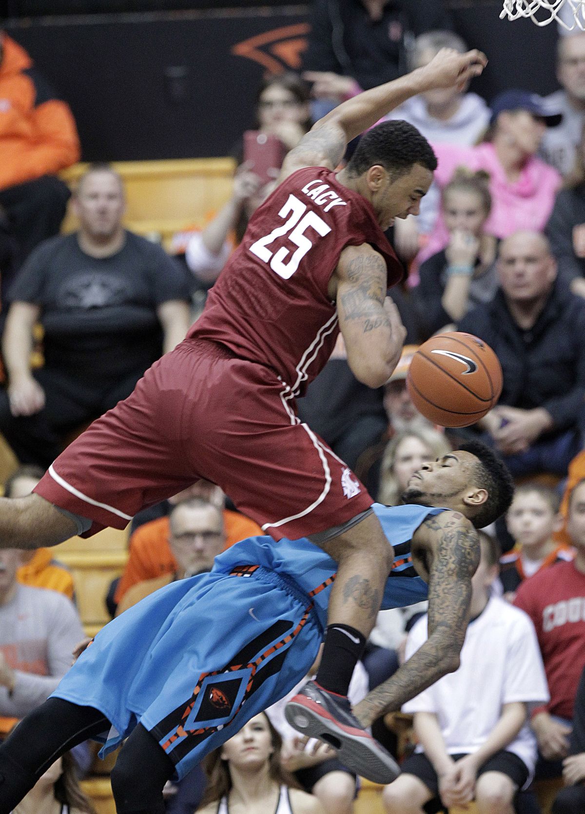 Cougars guard DaVonte Lacy collides with Oregon State forward Eric Moreland on his way to the basket. (Associated Press)