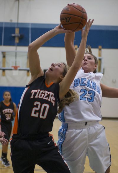 Central Valley's Brooke Gallaway, right, gets a hand on the ball as Lewis and Clark's Taylor Howlett shoots during the Bears’ 75-55 GSL home victory on Tuesday night. (Colin Mulvany)