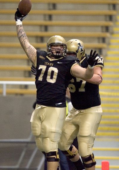 Idaho offensive lineman Matt Cleveland (70) celebrates with teammate Tyrone Novikoff after running in a fumble by Princeton McCarty for (Associated Press)