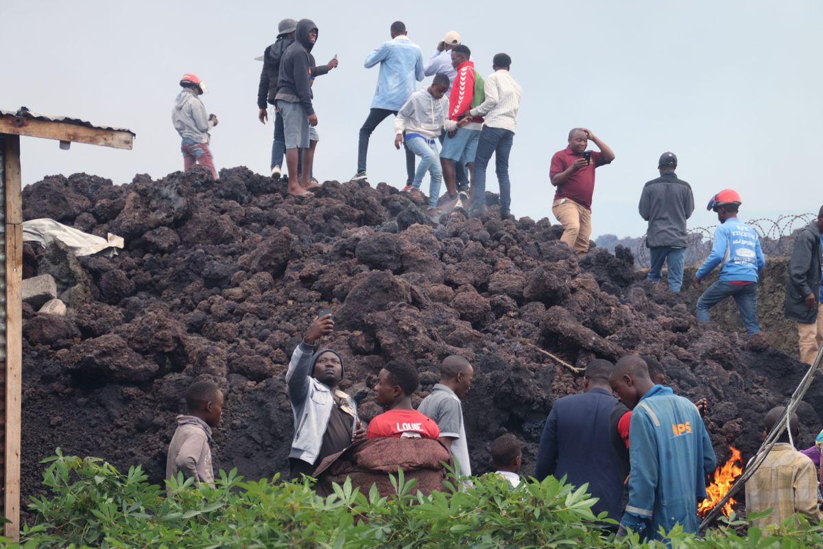People gather on a stream of cold lava rock following the overnight eruption of Mount Nyiragongo in Goma, Congo, Sunday, May 23, 2021. Witnesses say Congo’s Mount Nyiragongo volcano unleashed lava that destroyed homes on the outskirts of Goma but the city of nearly 2 million was mostly spared after the nighttime eruption. Residents of the Buhene area said many homes had caught fire as lava oozed into their neighborhood.  (Justin Kabumba)