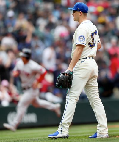 Seattle Mariners reliever Paul Sewald looks on as Boston Red Sox's Rob Refsnyder rounds third on Rafael Devers two-run home run in the eighth inning to give Red Sox a 2-0 lead Sunday, June 12, 2022, in Seattle.  (Tribune News Service)