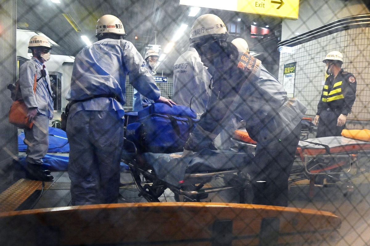 Rescuers papare stretchers at Soshigaya Okura Station after stabbing on a commuter train, in Tokyo Friday, Aug. 6, 2021. A man with a knife stabbed passengers on a commuter train Friday and was arrested by police after fleeing, fire department officials and news reports said.  (SUB)