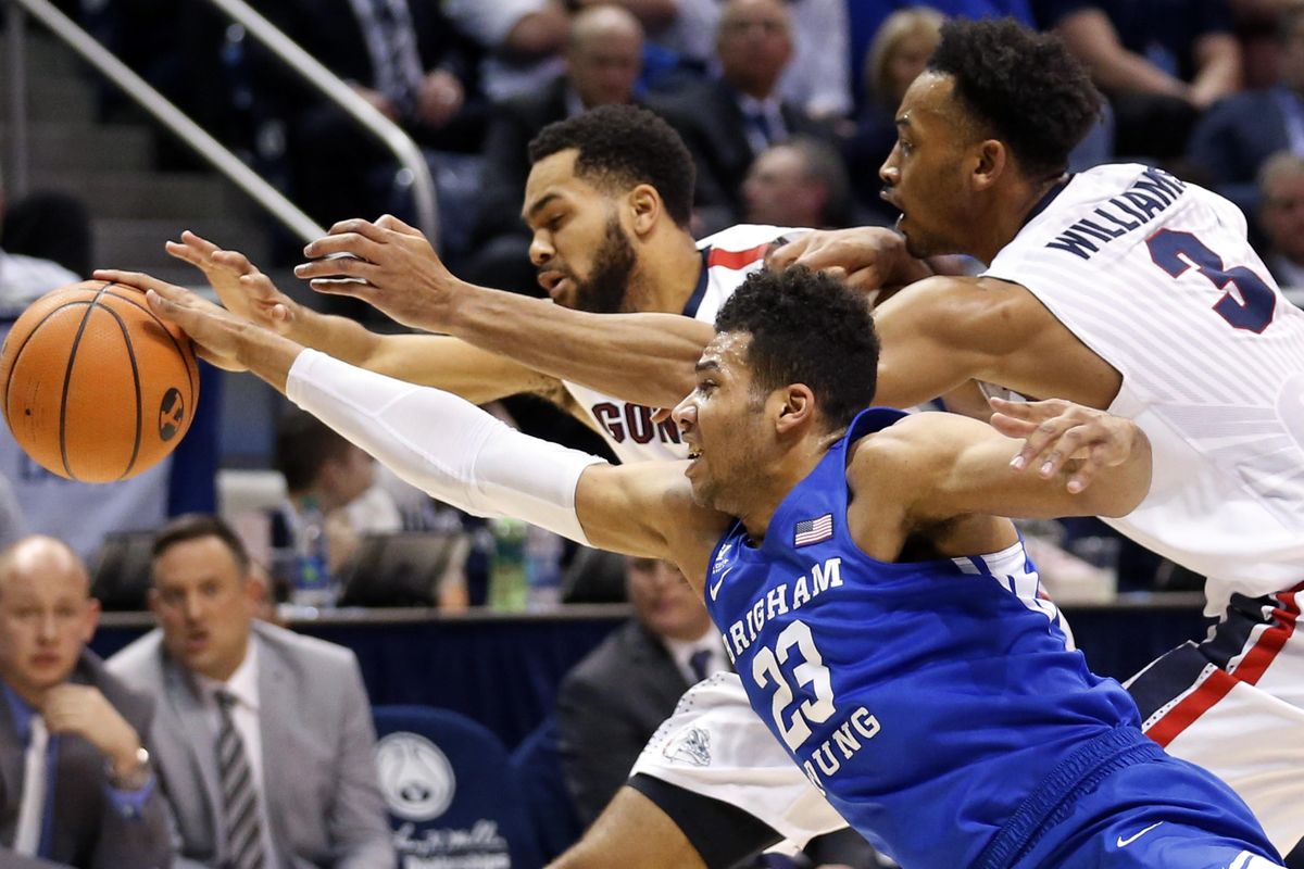 Gonzaga’s Silas Melson and Johnathan Williams vie for a loose ball with BYU forward Yoeli Childs in Provo, Utah. (Rick Bowmer / Associated Press)