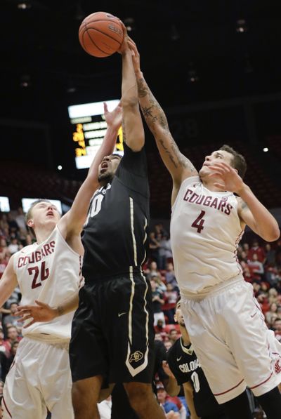 WSU’s Josh Hawkinson, left, and Jordan Railey, right, harass Colorado’s Josh Scott. (Associated Press)