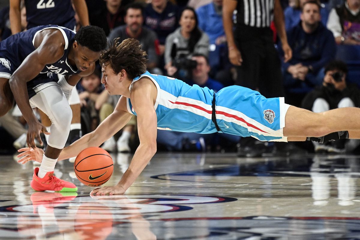 Gonzaga forward Braden Huff dives for a loose ball with Yale guard Bez Mbeng during the second half of the Zags’ 86-71 victory Friday.  (By Colin Mulvany/The Spokesman-iew)