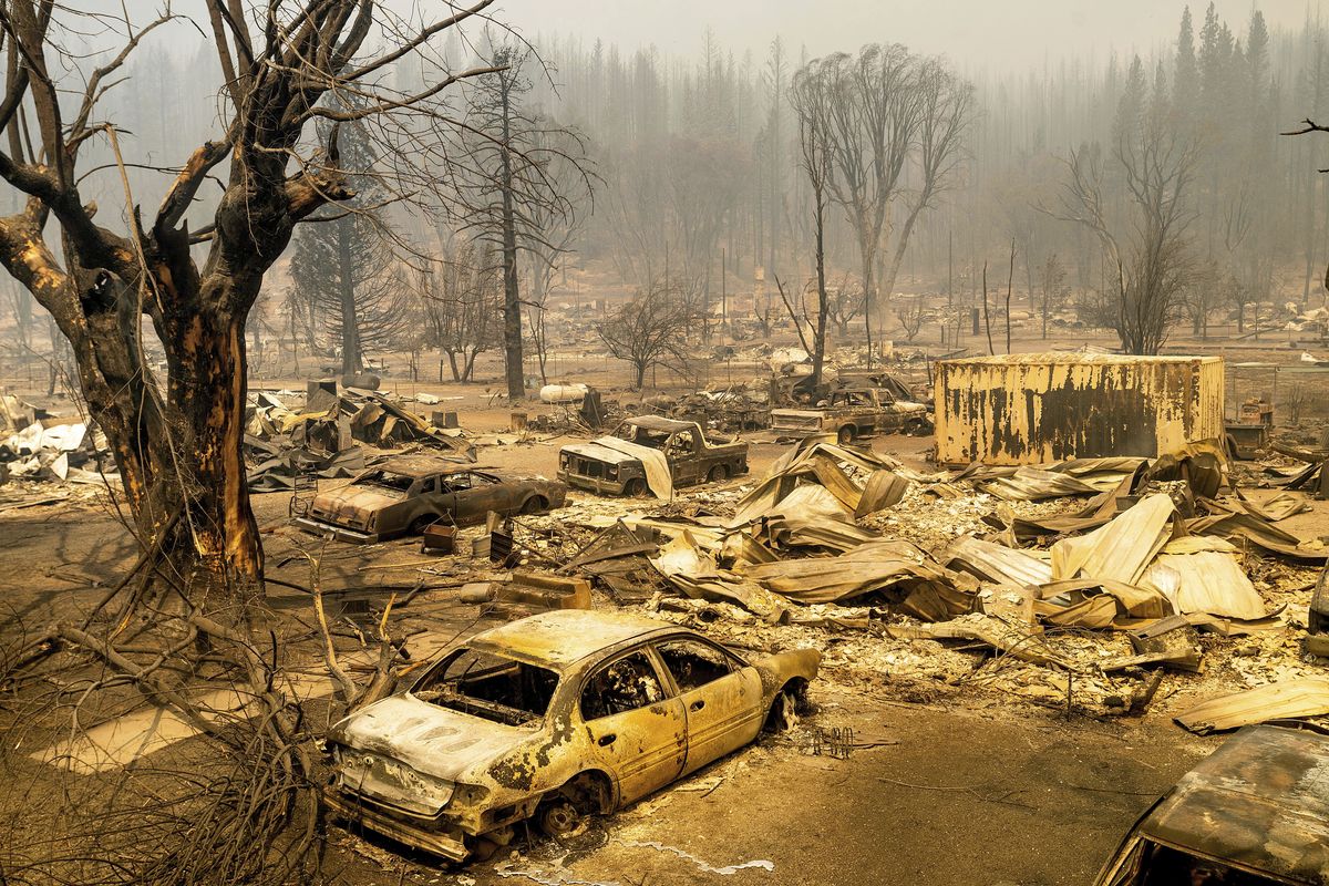 This photo shows cars and homes destroyed by the Dixie Fire line central Greenville on Thursday, Aug. 5, 2021, in Plumas County, Calif.  (Noah Berger)