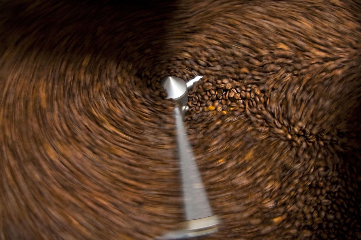 Coffee beans are swirled around during the roasting process at DOMA Coffee Roasting in Post Falls on Thursday, Oct. 19, 2017. (Kathy Plonka/THE SPOKESMAN-REVIEW)