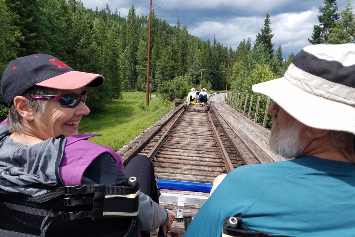 Jane and Ron McDonald pedal a rail rider over a small trestle on the railroad tracks along the Pend Oreille River. (Rich Landers / The Spokesman-Review)